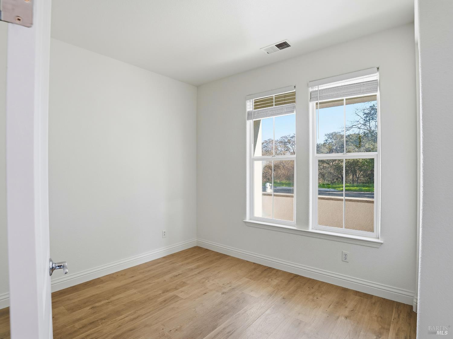 4424 Streamside Drive Santa Rosa, CA 95409 - Photo 27 of 55 a view of an empty room with wooden floor and a window
