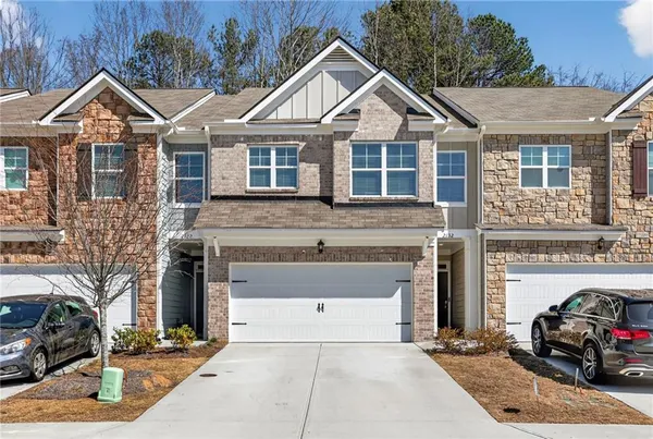 a front view of a house with parking space