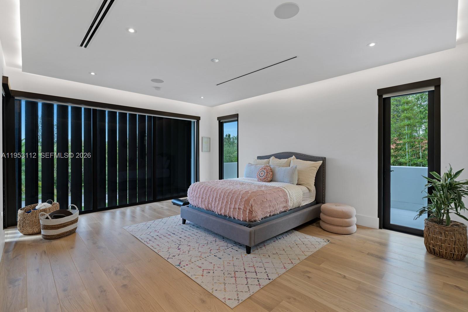 6031 Southwest 88th Street Miami, FL 33156 - Photo 34 of 81 a spacious bedroom with a bed and a potted plant