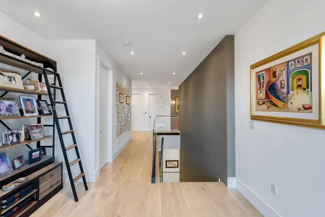 a view of a swimming pool with lawn chairs under an umbrella