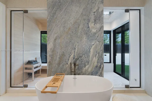 a view of a chair and table in backyard of the house