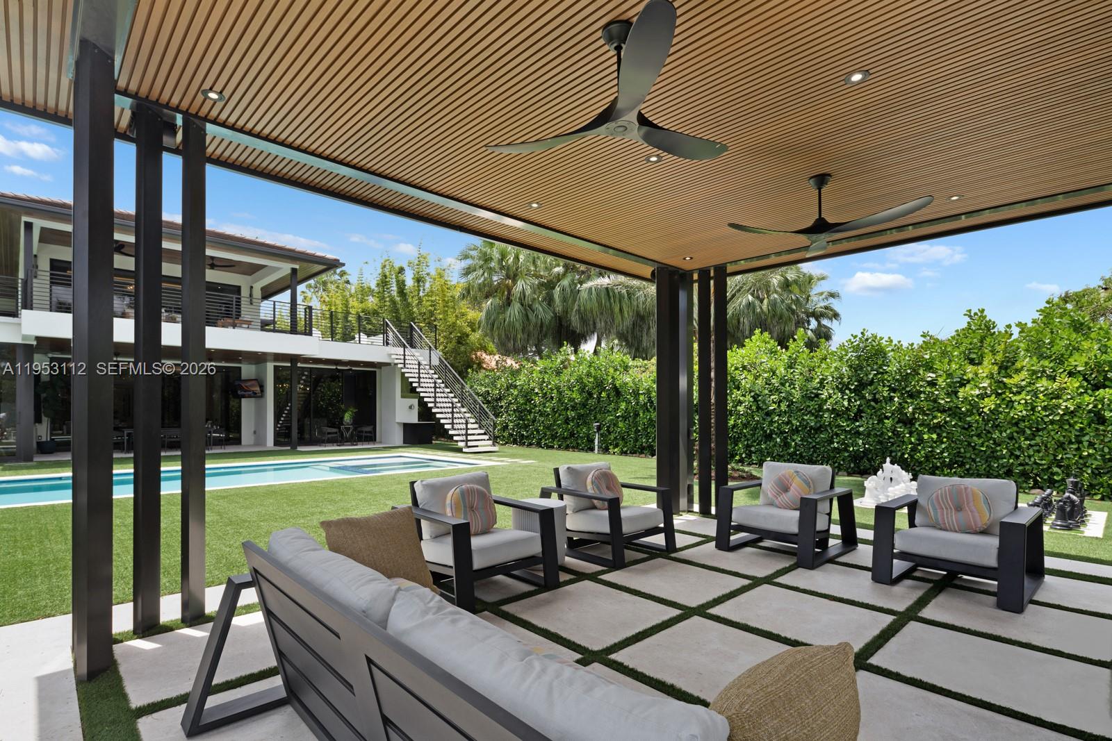6031 Southwest 88th Street Miami, FL 33156 - Photo 48 of 81 a view of a patio with table and chairs potted plants with floor to ceiling window