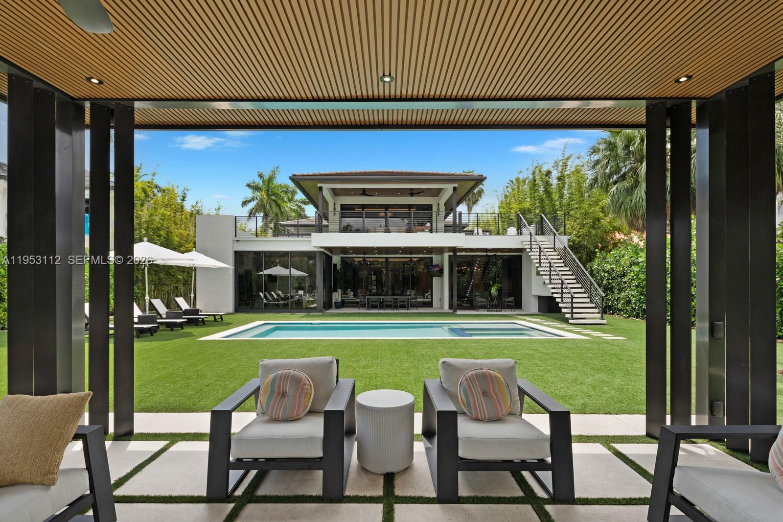 6031 Southwest 88th Street Miami, FL 33156 - Photo 49 of 81 a view of a chairs and table in the patio with a yard