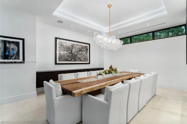 a living room with furniture a flat screen tv and a large window
