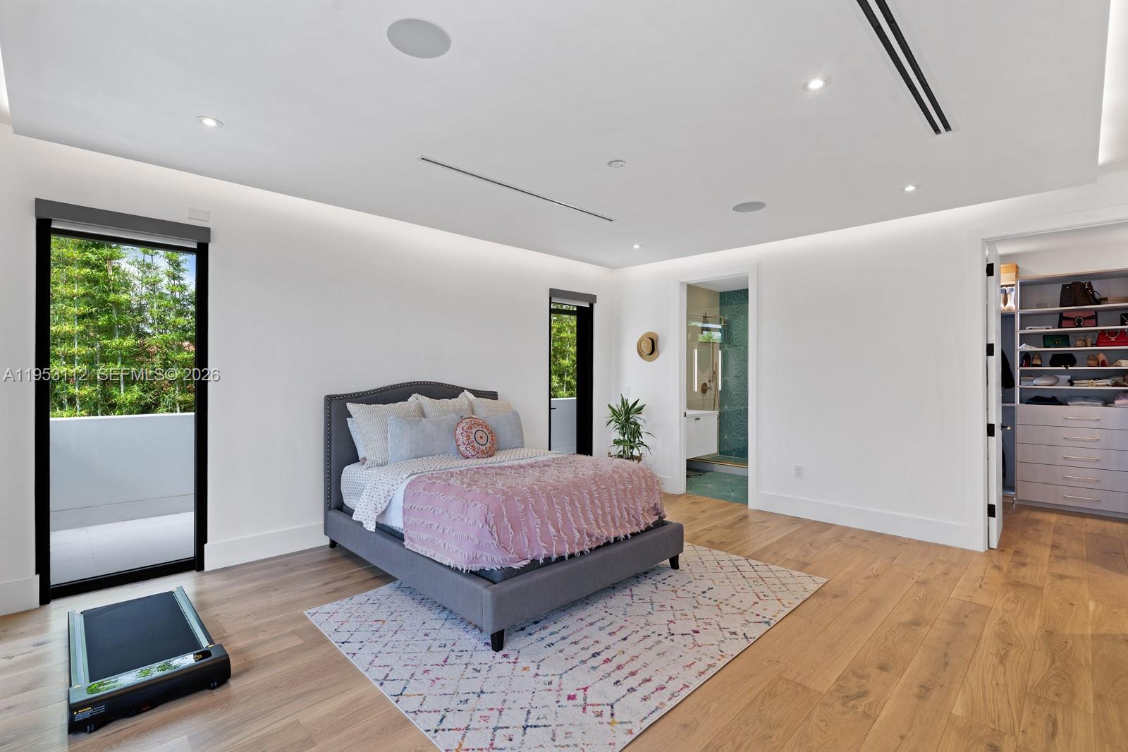 6031 Southwest 88th Street Miami, FL 33156 - Photo 70 of 81 a bedroom with a large bed a rug and a window