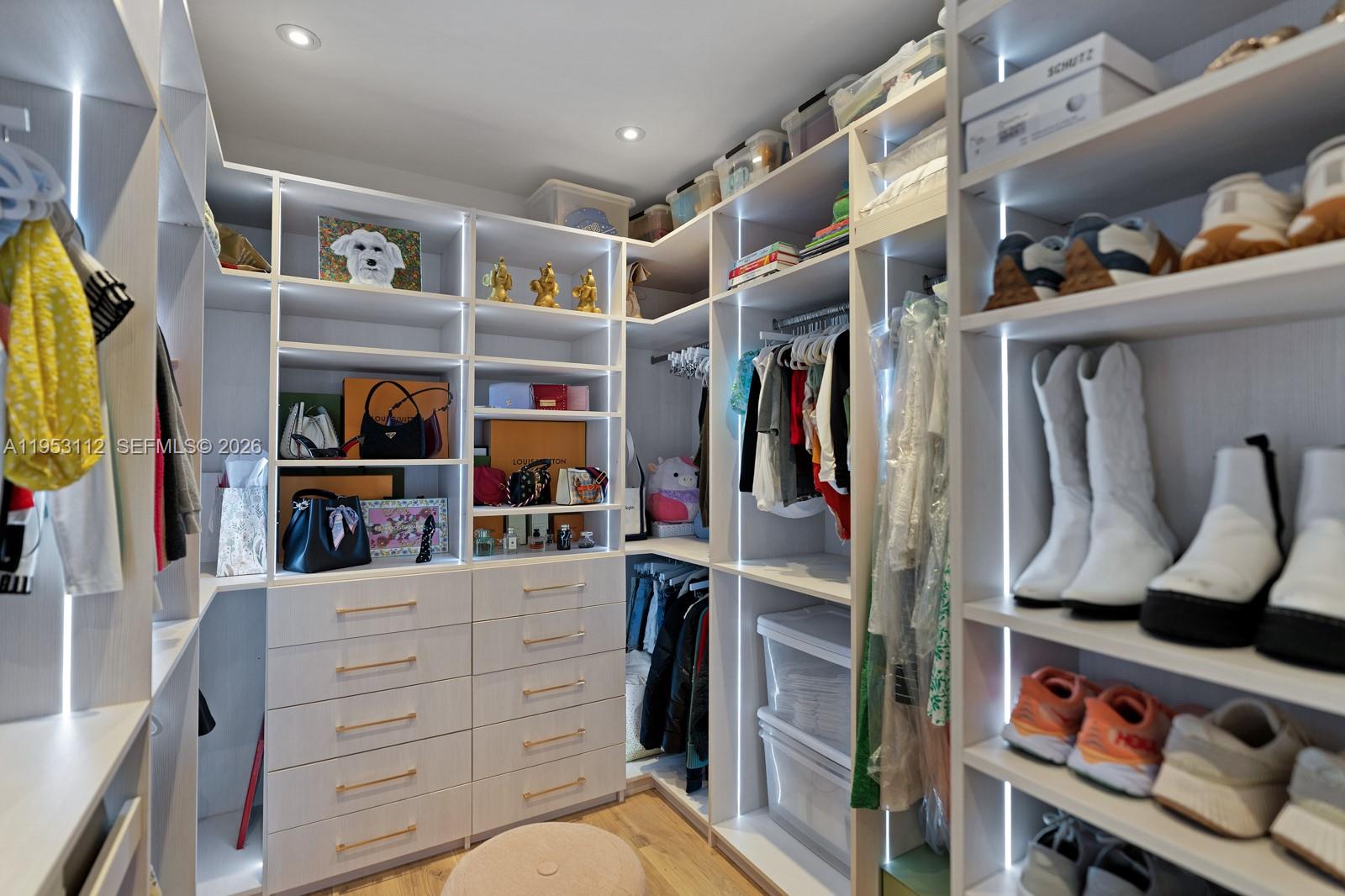 6031 Southwest 88th Street Miami, FL 33156 - Photo 73 of 81 a view of walk in closet with clothes and shoes