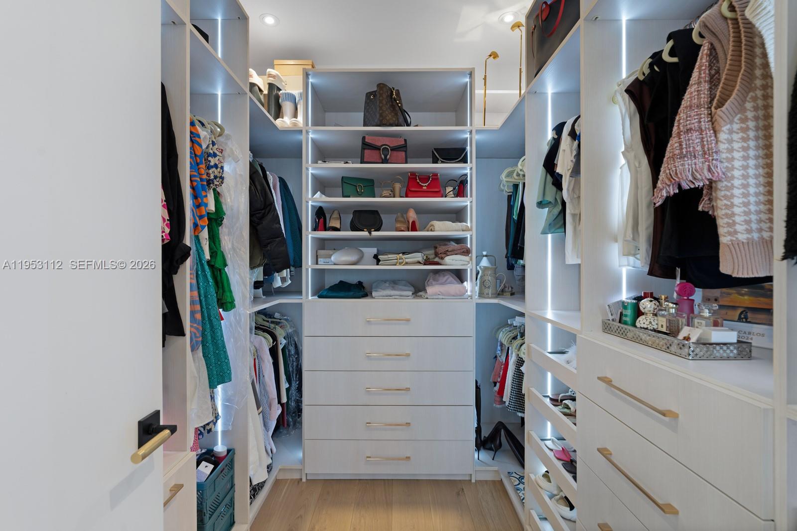 6031 Southwest 88th Street Miami, FL 33156 - Photo 74 of 81 a view of walk in closet with clothes and shoes
