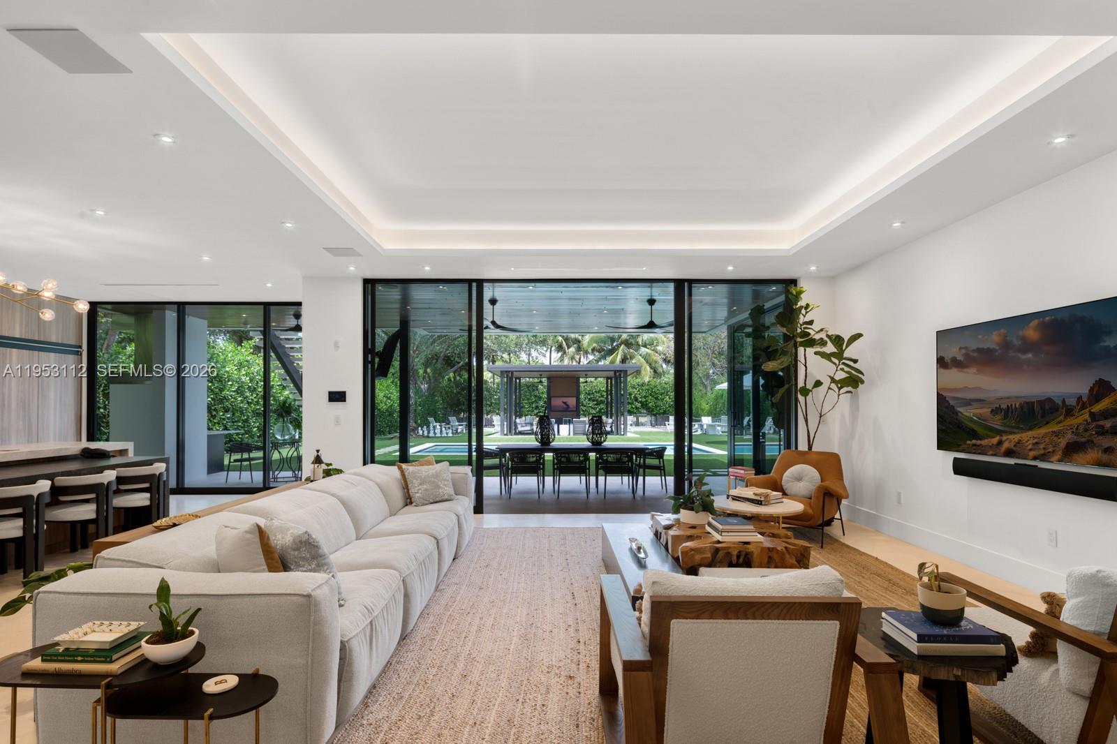 6031 Southwest 88th Street Miami, FL 33156 - Photo 9 of 81 a living room with furniture a flat screen tv and a large window