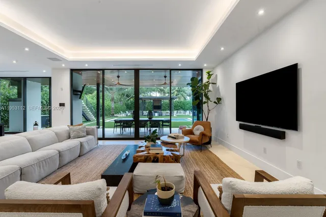 a kitchen with a table chairs refrigerator and microwave