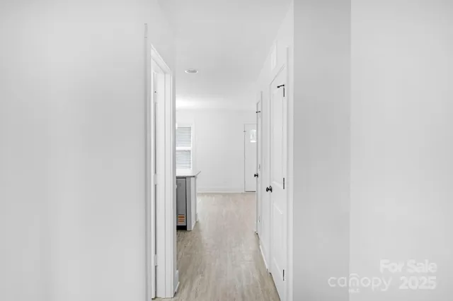 a view of a room with wooden floor