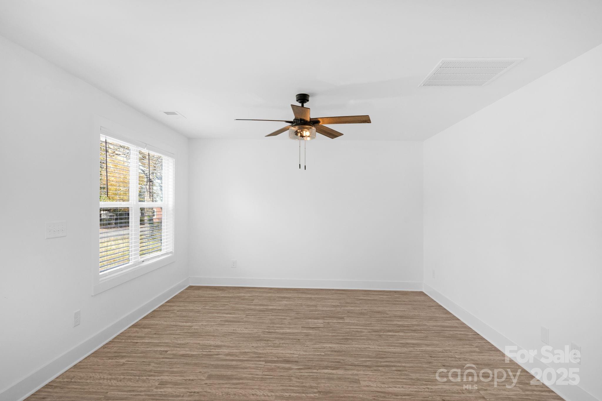 324 Ashford Street Chester, SC 29706 - Photo 17 of 20 a view of empty room with wooden floor and fan