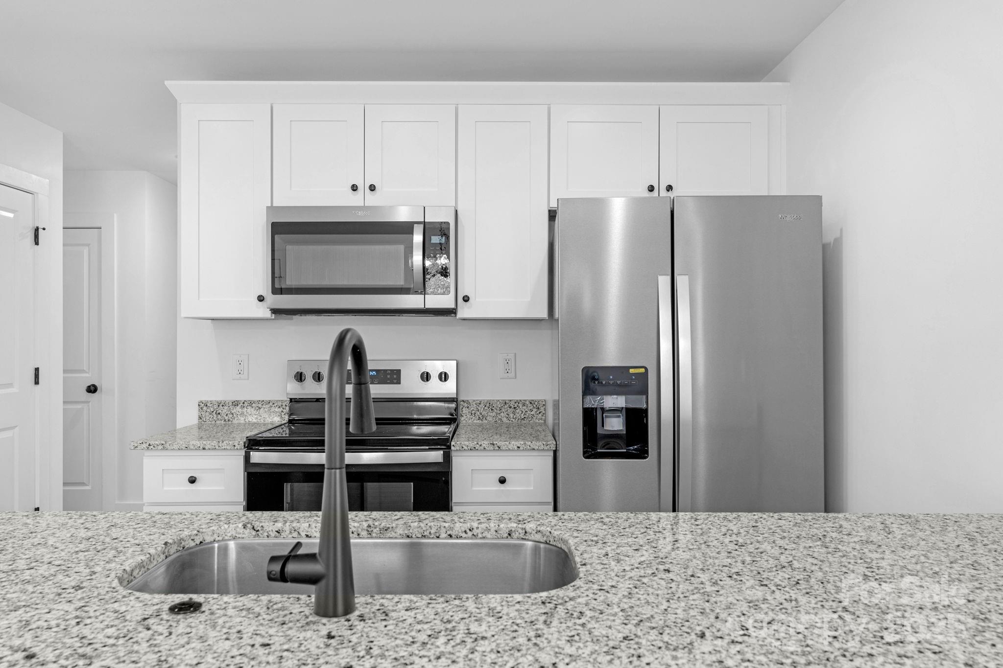 324 Ashford Street Chester, SC 29706 - Photo 3 of 20 a kitchen with stainless steel appliances kitchen island granite countertop a refrigerator and a stove top oven