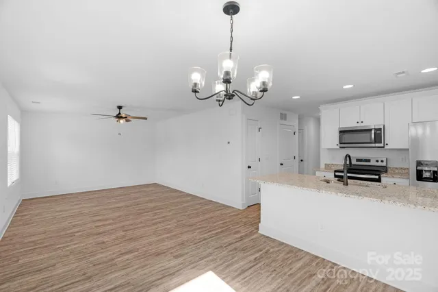 a view of a kitchen with stove and microwave