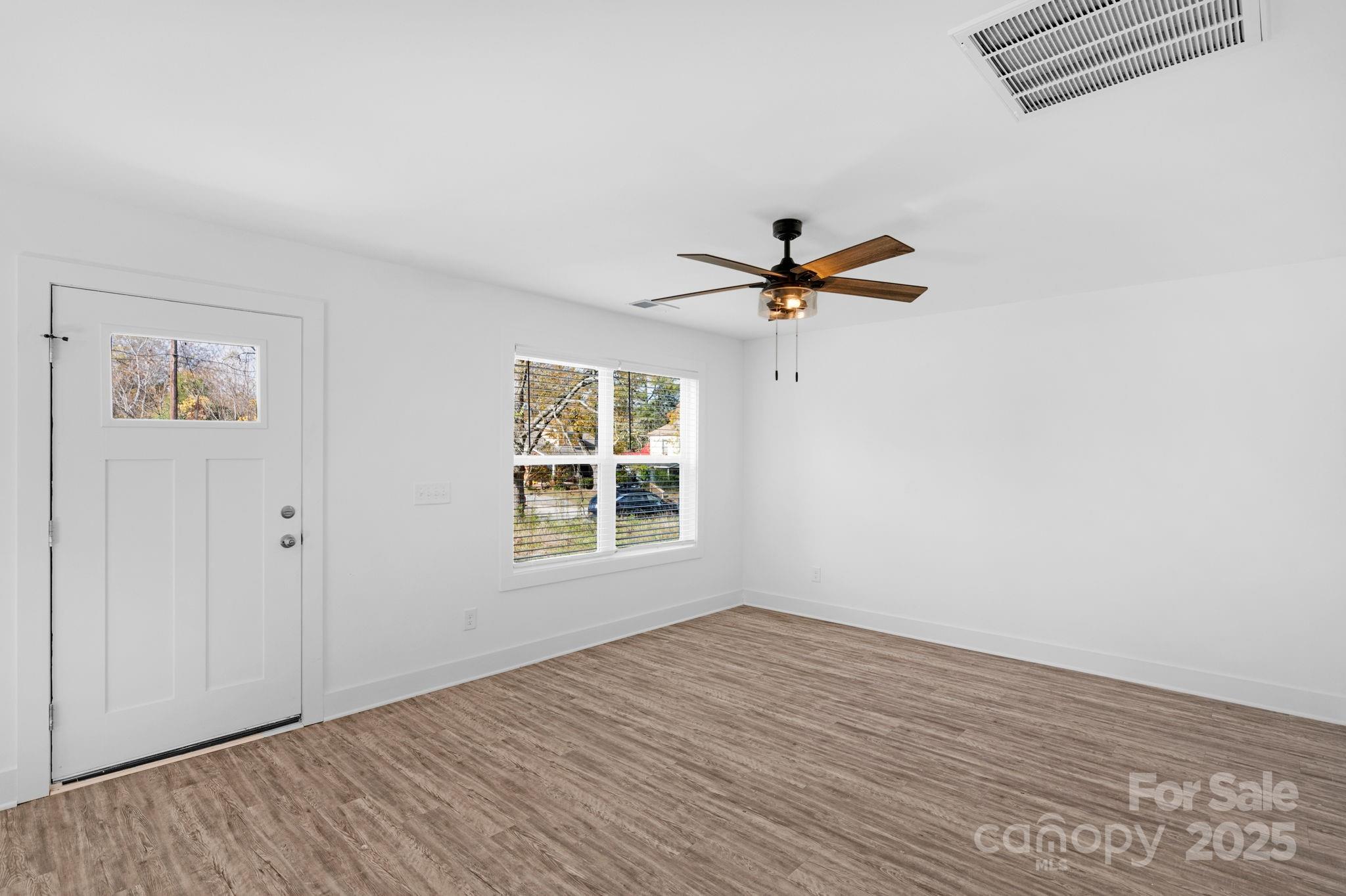 324 Ashford Street Chester, SC 29706 - Photo 5 of 20 a view of a room with a window and wooden floor