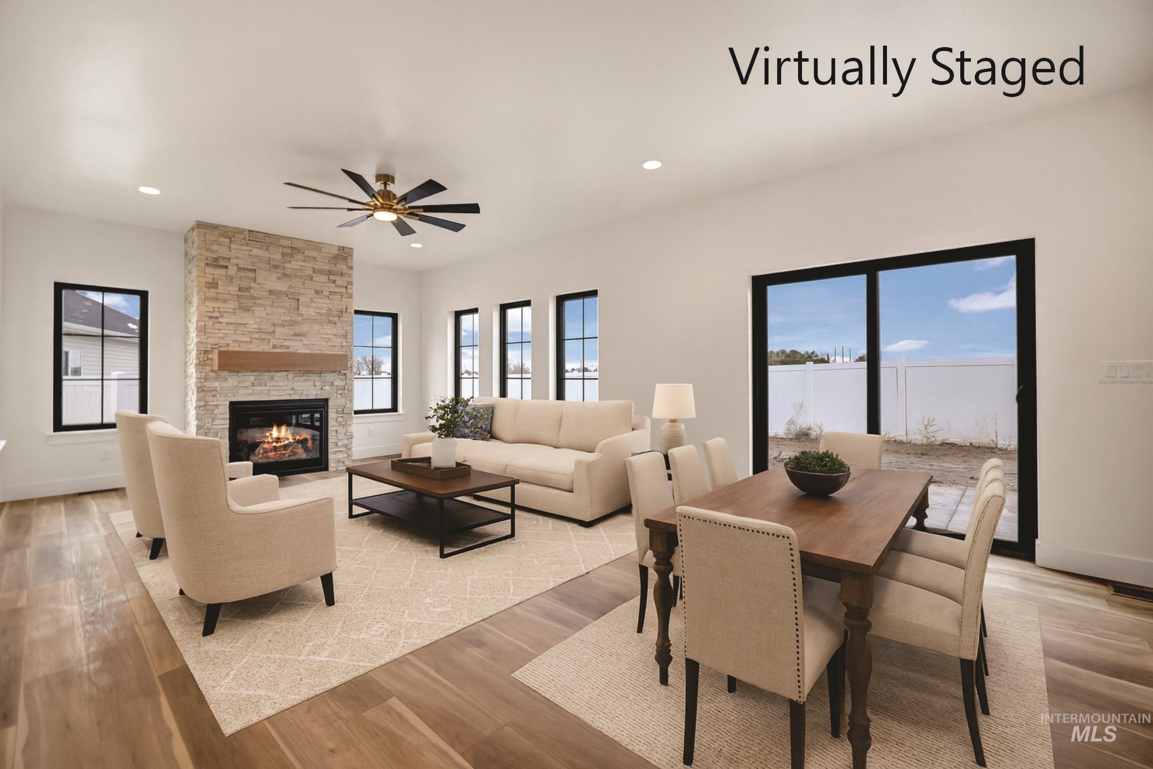 696 Full Moon Way Twin Falls, ID 83301 - Photo 13 of 48 Dining room with light wood-style flooring, a stone fireplace, a ceiling fan, and recessed lighting
