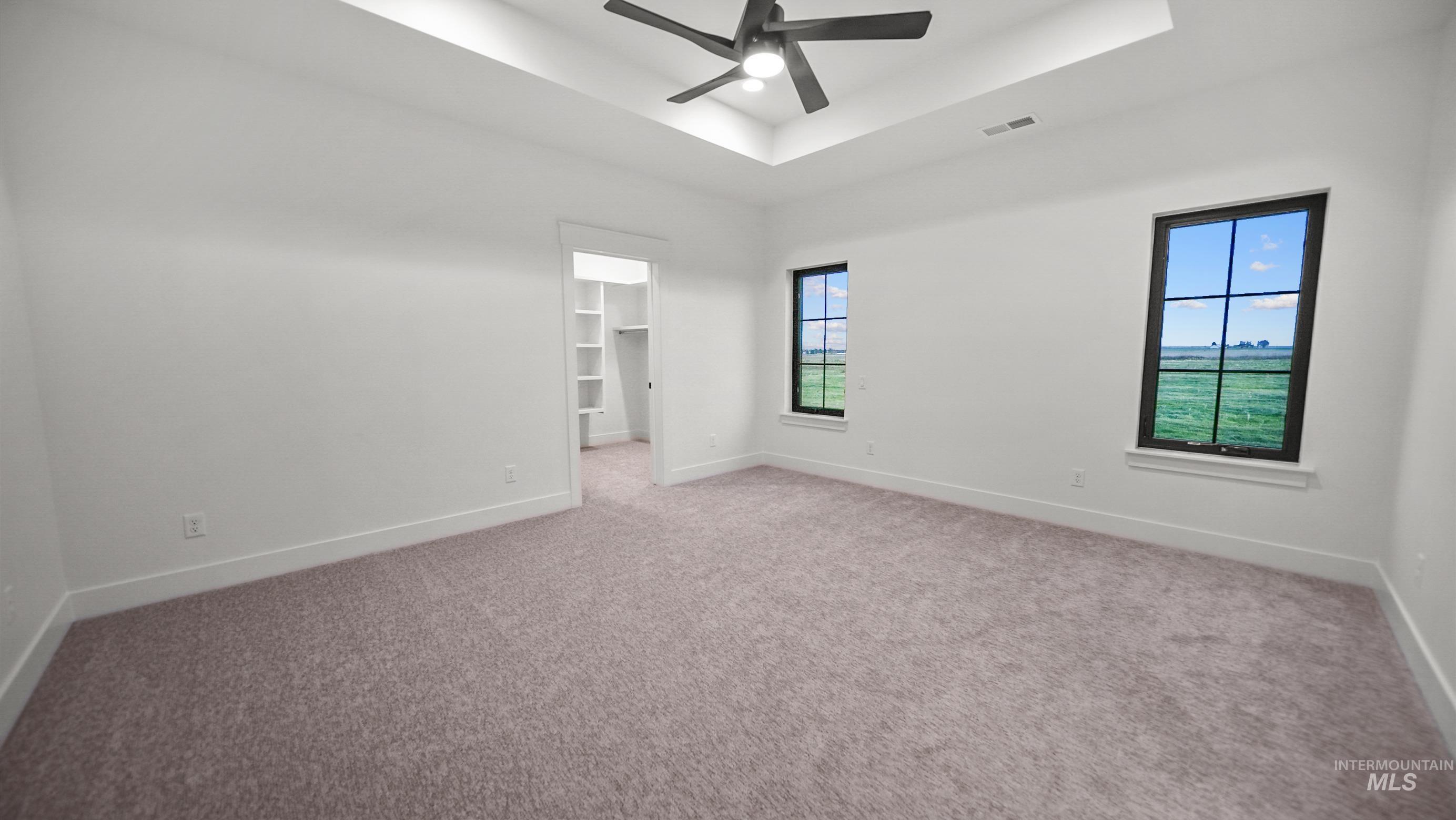 696 Full Moon Way Twin Falls, ID 83301 - Photo 21 of 48 Carpeted empty room with a tray ceiling and a ceiling fan