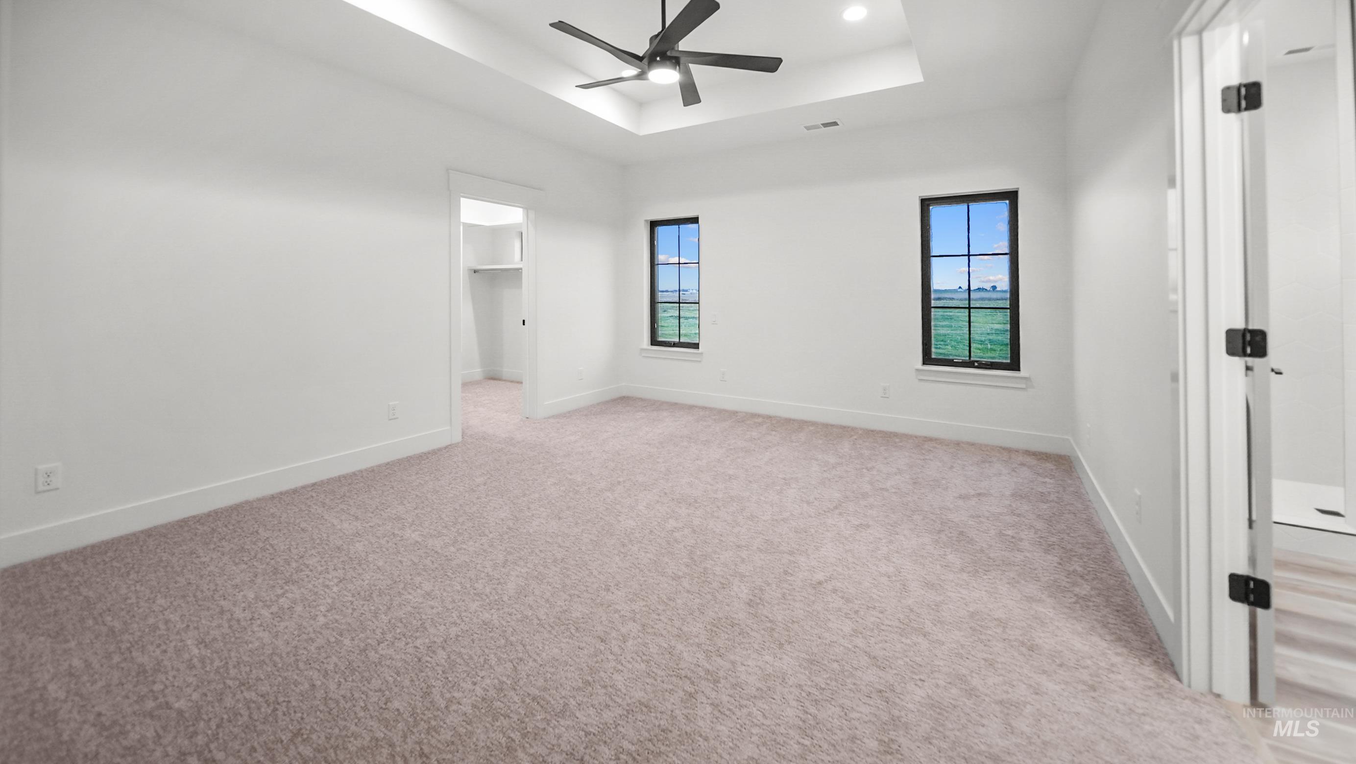 696 Full Moon Way Twin Falls, ID 83301 - Photo 22 of 48 Unfurnished bedroom with a spacious closet, a raised ceiling, a ceiling fan, light carpet, and recessed lighting