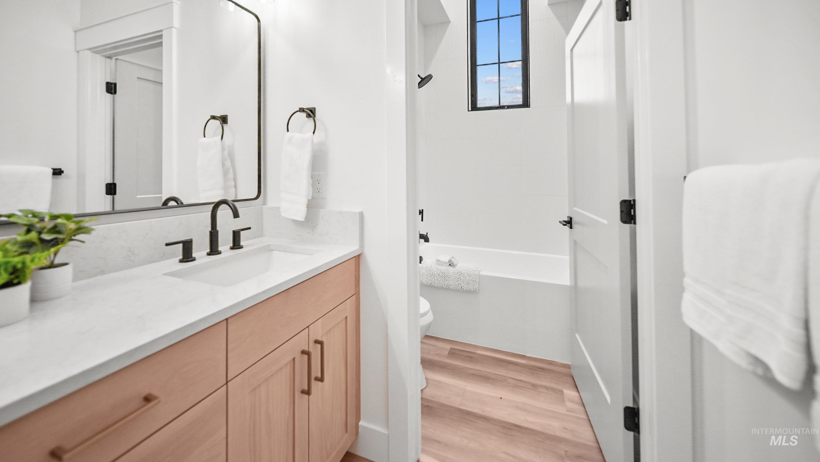 696 Full Moon Way Twin Falls, ID 83301 - Photo 30 of 48 Full bath featuring vanity, light wood finished floors, and shower combination