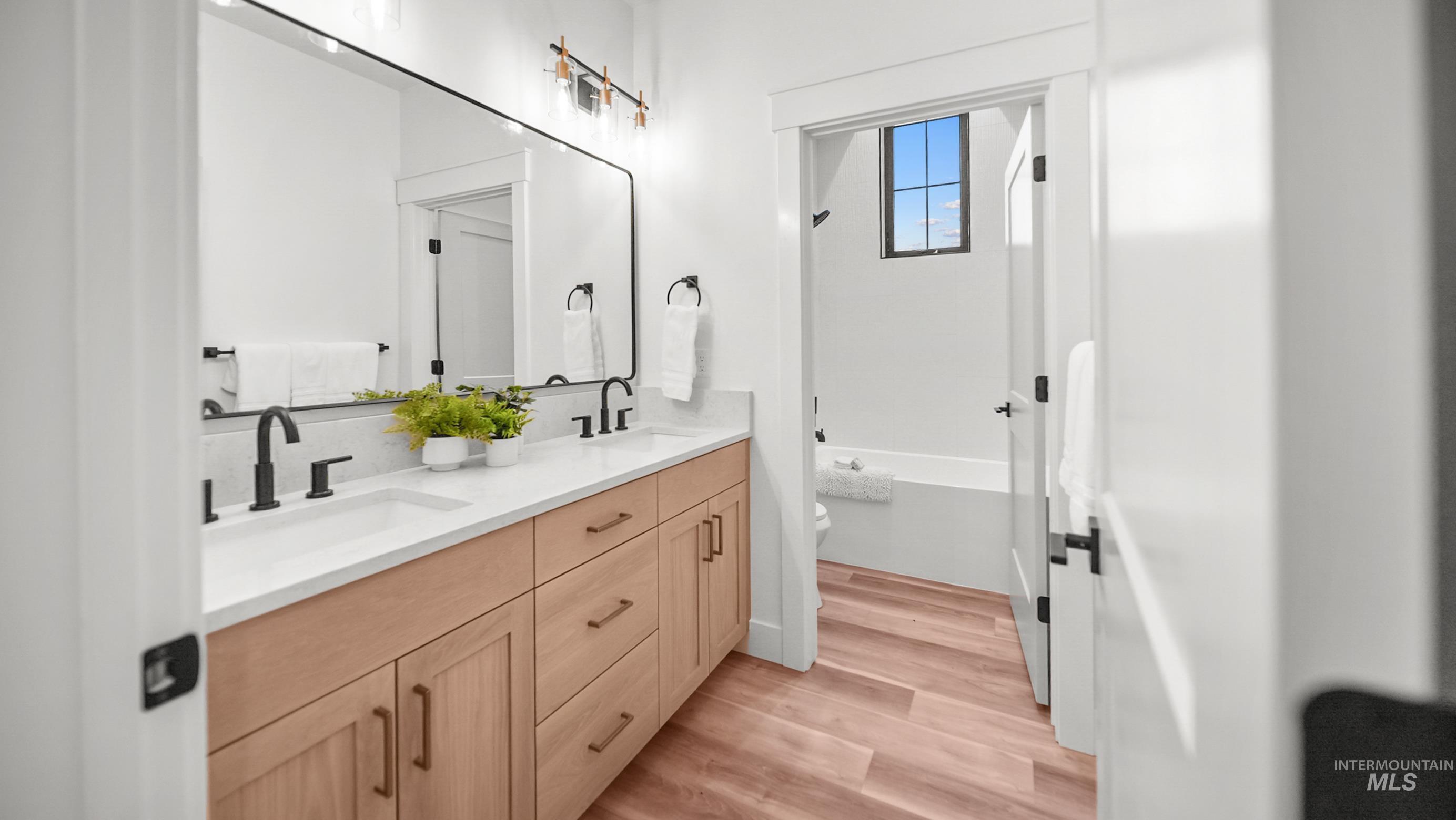 696 Full Moon Way Twin Falls, ID 83301 - Photo 31 of 48 Bathroom featuring double vanity and light wood-style flooring