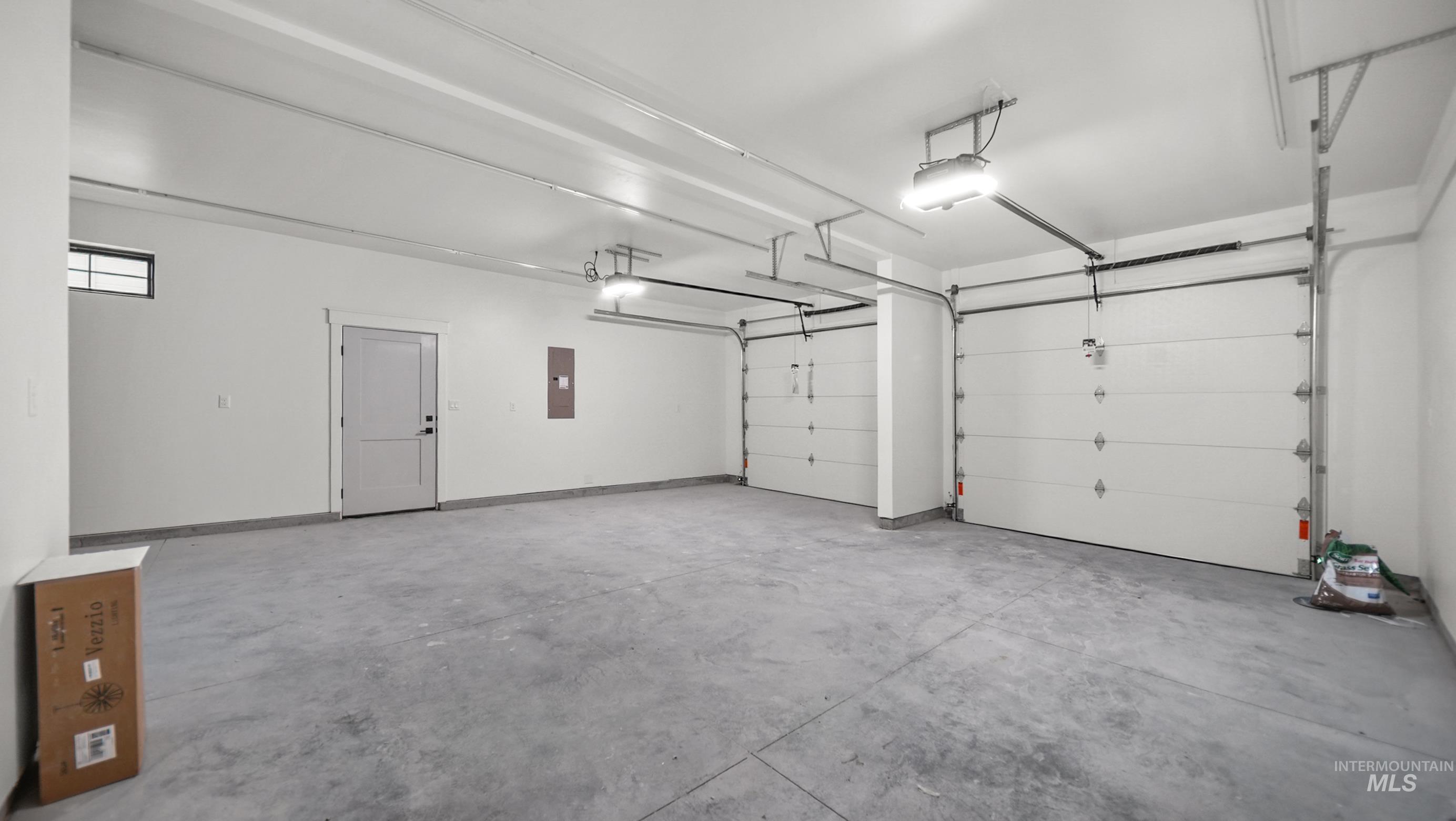 696 Full Moon Way Twin Falls, ID 83301 - Photo 33 of 48 Garage with a garage door opener and electric panel