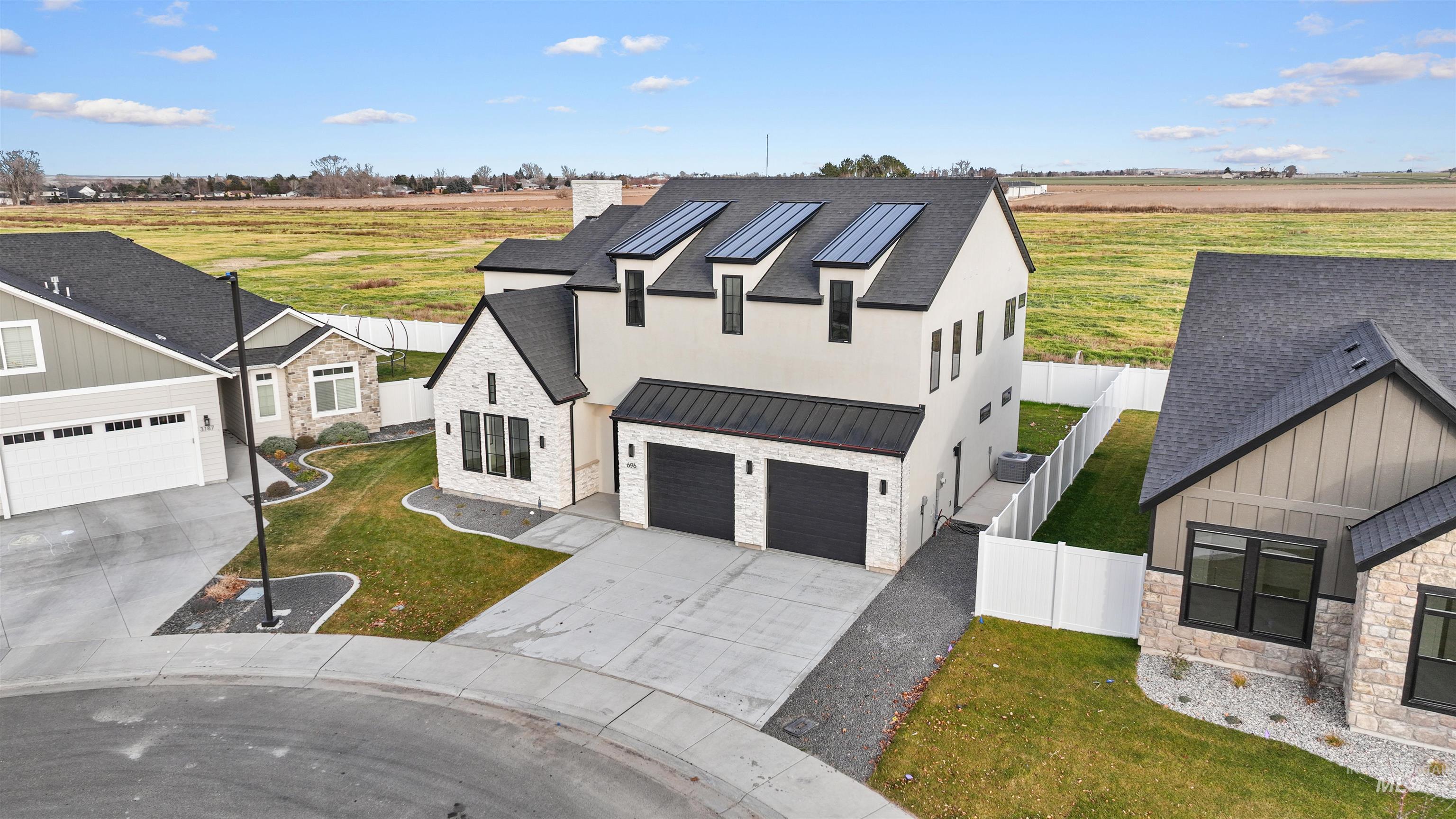 696 Full Moon Way Twin Falls, ID 83301 - Photo 38 of 48 View of front of home featuring stone siding, a standing seam roof, a view of countryside, and a metal roof