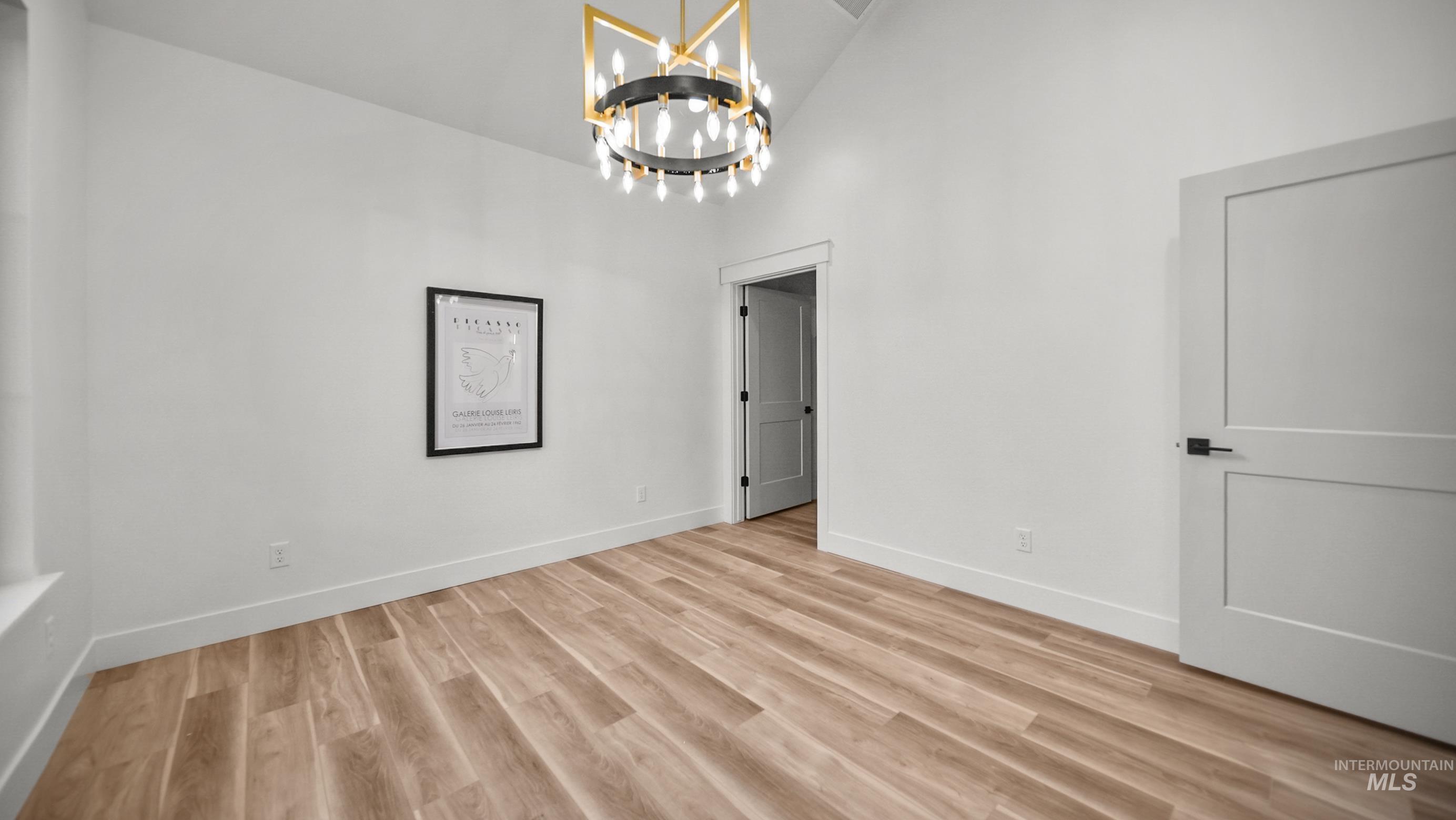 696 Full Moon Way Twin Falls, ID 83301 - Photo 4 of 48 Unfurnished dining area with a chandelier, high vaulted ceiling, and light wood finished floors