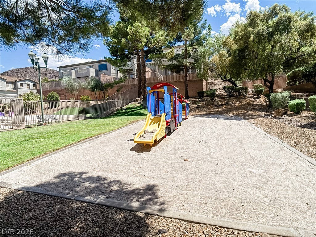 228 Positive Point Street Henderson, NV 89012 - Photo 26 of 27 A vibrant playground structure invites joyful outdoor recreation, nestled within a well-maintained community space.