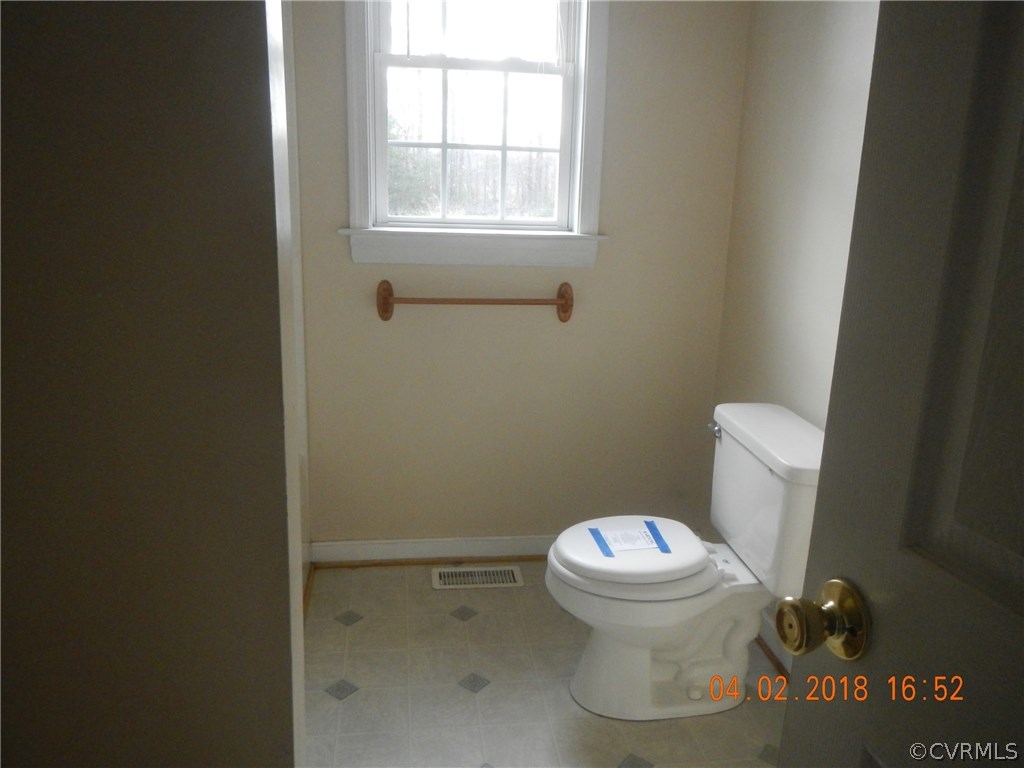 24480 Johnson Road Jetersville, VA 23083 - Photo 11 of 16 a white toilet sitting next to a window
