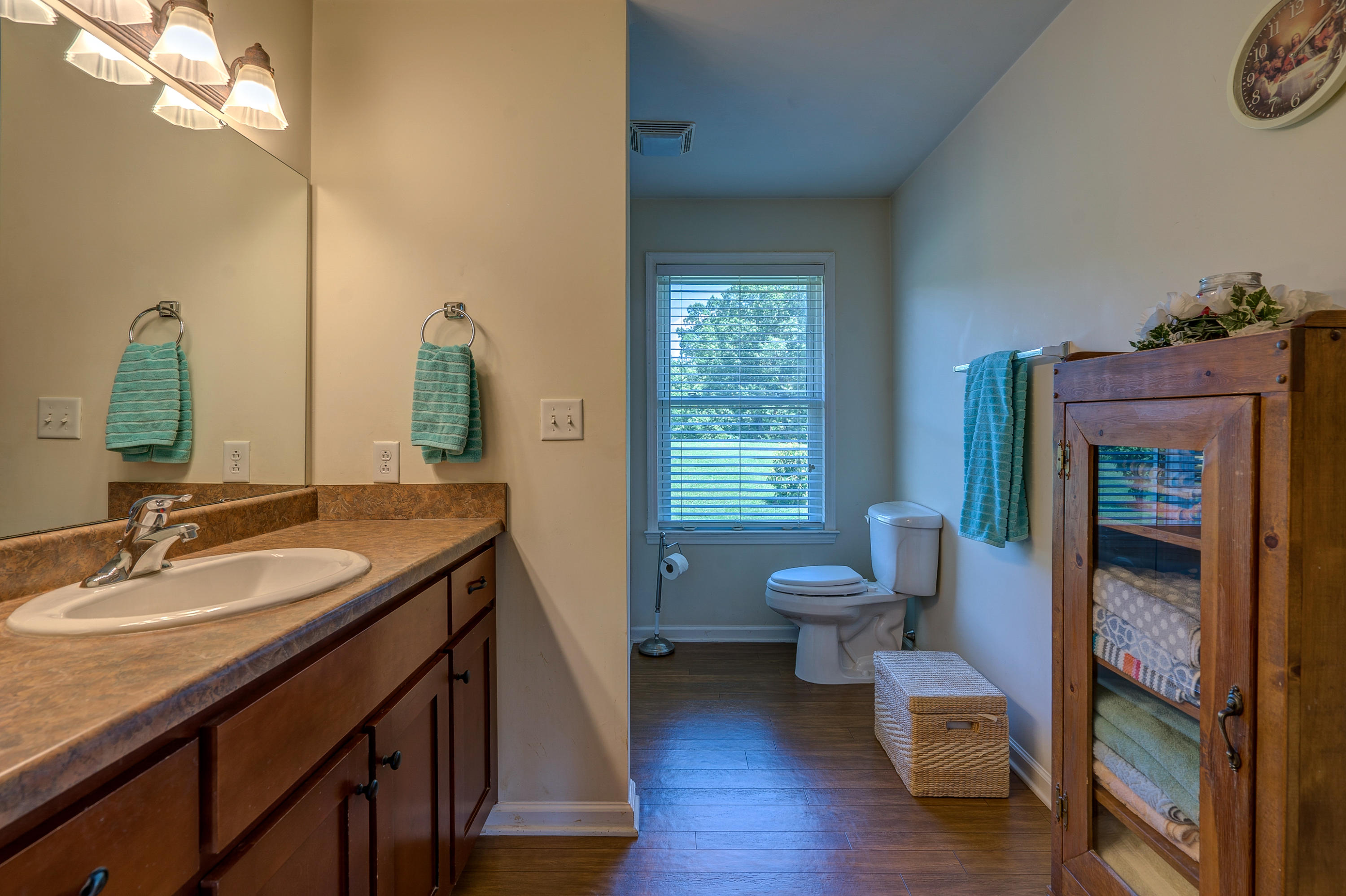 3007 Sandy Level Road Goodview, VA 24095 - Photo 42 of 51 a bathroom with a granite countertop sink a toilet and a mirror