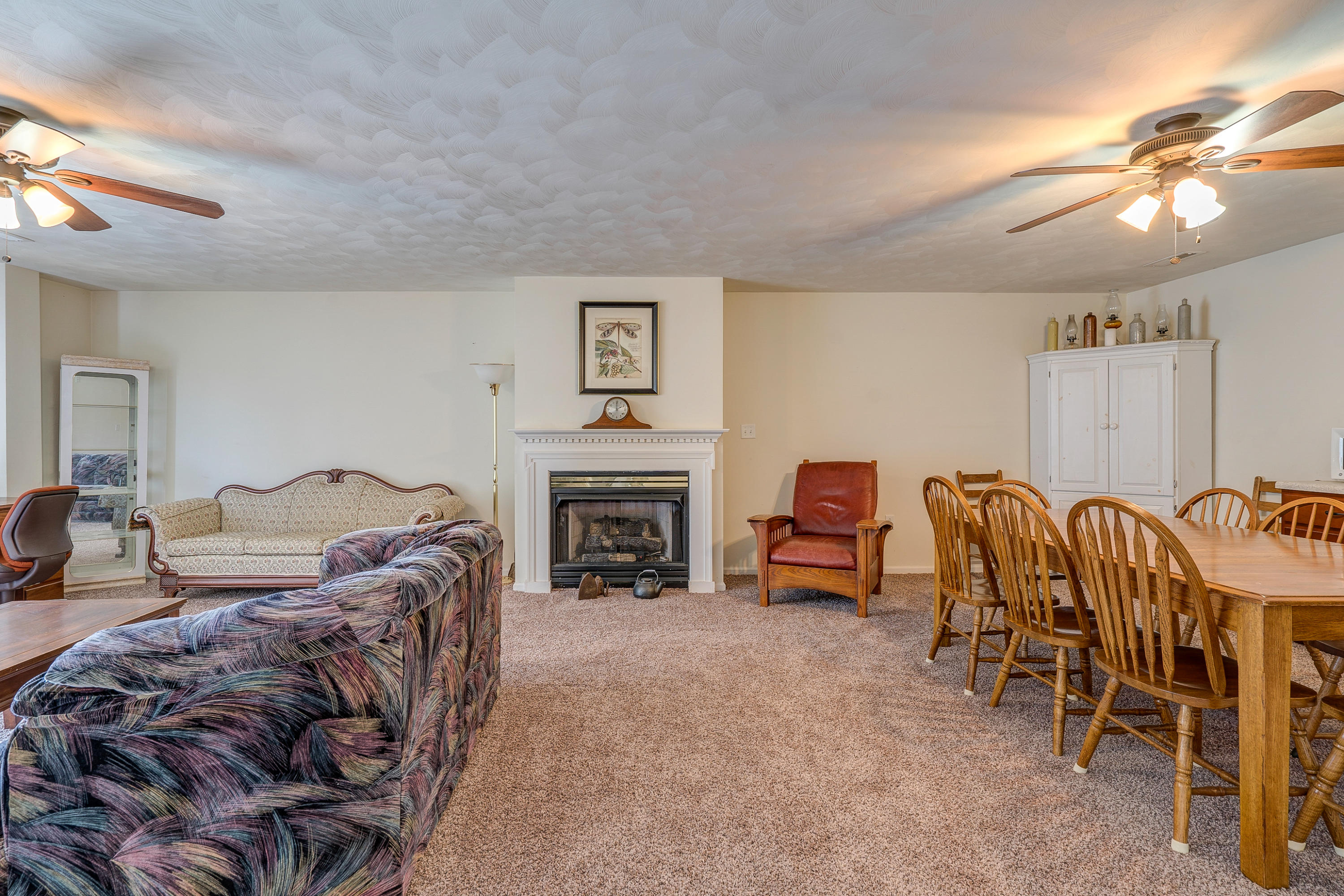 3007 Sandy Level Road Goodview, VA 24095 - Photo 45 of 51 a living room with furniture a fireplace and a chandelier