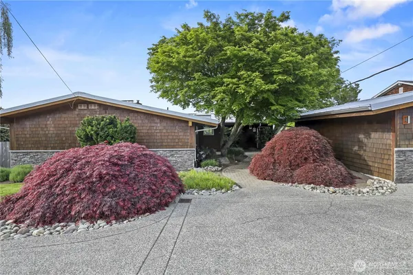 a view of a house with a yard and garage