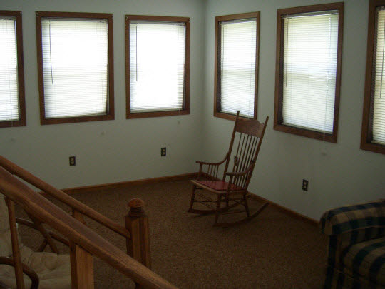 4505 Simpson Road Rockford, IL 61102 - Photo 7 of 10 a view of a room with a window and wooden floor