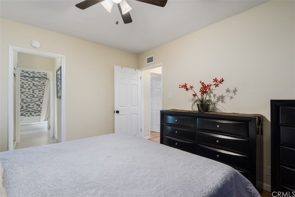 7955 Brookpark Road Downey, CA 90240 - Photo 14 of 27 a bedroom with a bed and a chandelier