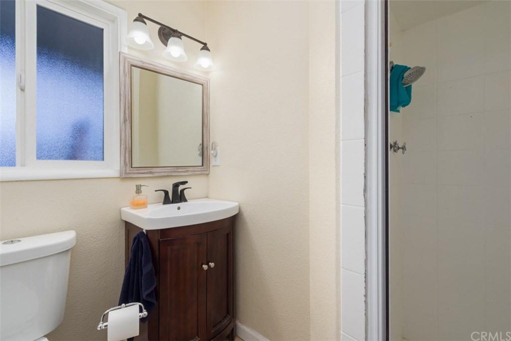 7955 Brookpark Road Downey, CA 90240 - Photo 19 of 27 a bathroom with a toilet sink and mirror