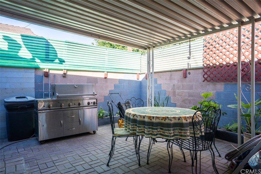 7955 Brookpark Road Downey, CA 90240 - Photo 21 of 27 a kitchen with a table chairs and stove