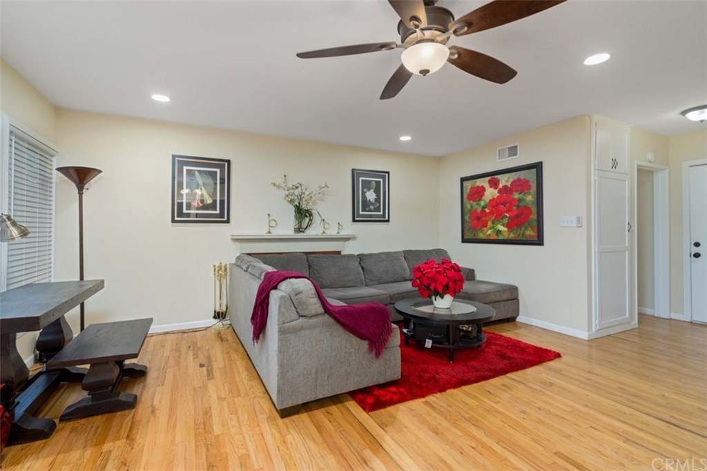 7955 Brookpark Road Downey, CA 90240 - Photo 5 of 27 a living room with furniture and a flat screen tv with wooden floor