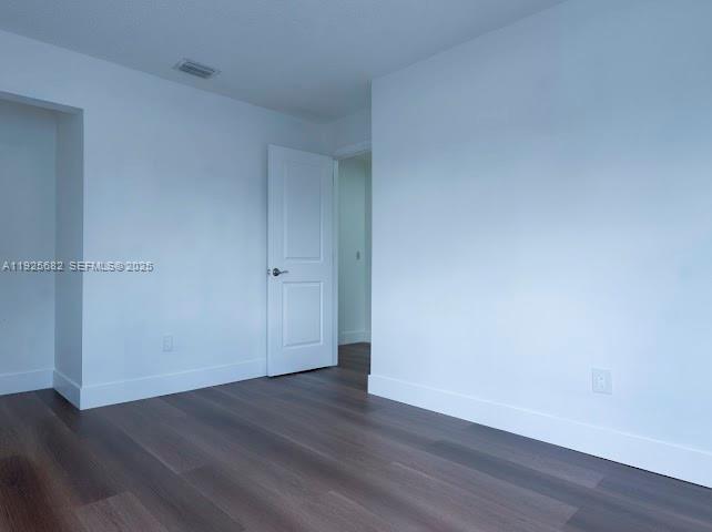 11475 Southwest 181st Street, Unit A Miami, FL 33157 - Photo 14 of 18 a view of an empty room with wooden floor