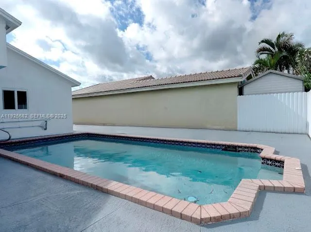 a view of a swimming pool with a yard