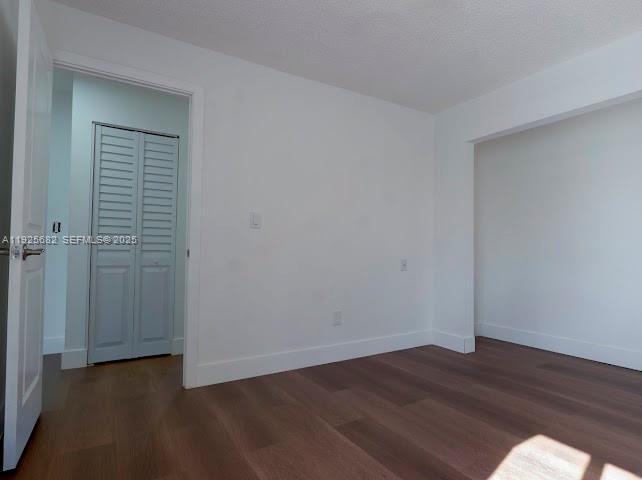 11475 Southwest 181st Street, Unit A Miami, FL 33157 - Photo 10 of 18 an empty room with wooden floor and closet