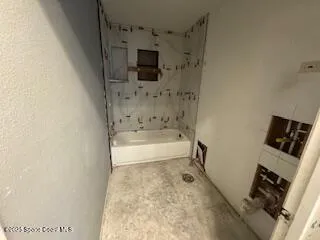 a bathroom with a bathtub and a toilet