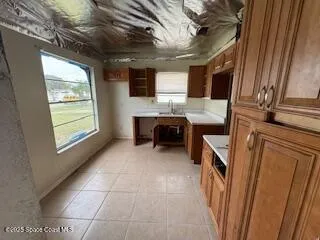 a view of a kitchen with furniture and windows