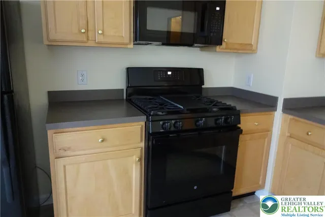 a view of staircase with railing and white walls
