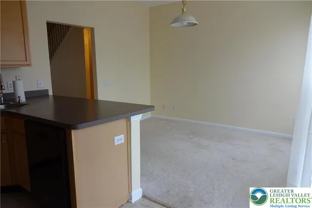 a bedroom with a bed and a flat tv screen on dresser