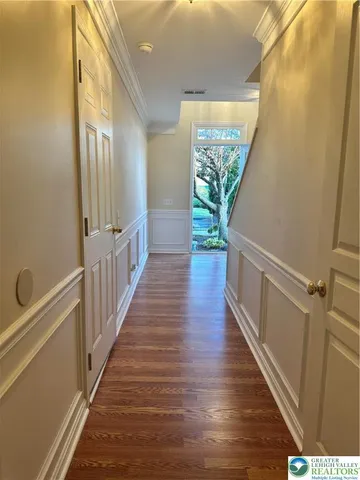 a kitchen with stainless steel appliances granite countertop a refrigerator a stove a microwave oven cabinets and a window