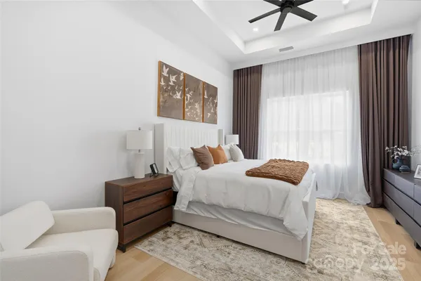 a bedroom with bed couch and window