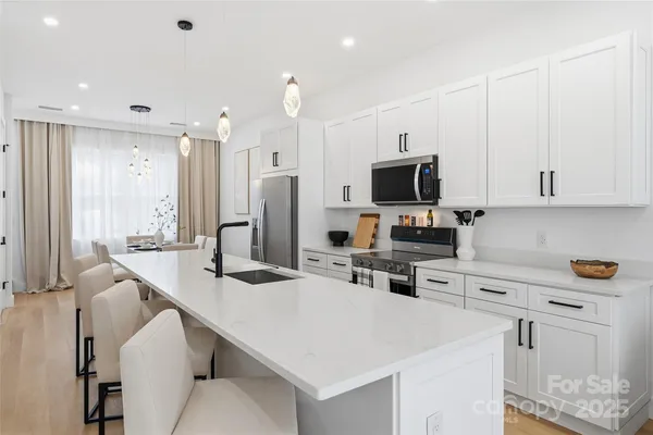 a kitchen with stainless steel appliances a stove microwave and refrigerator