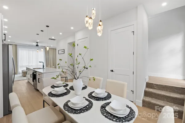 a dining room with furniture and wooden floor