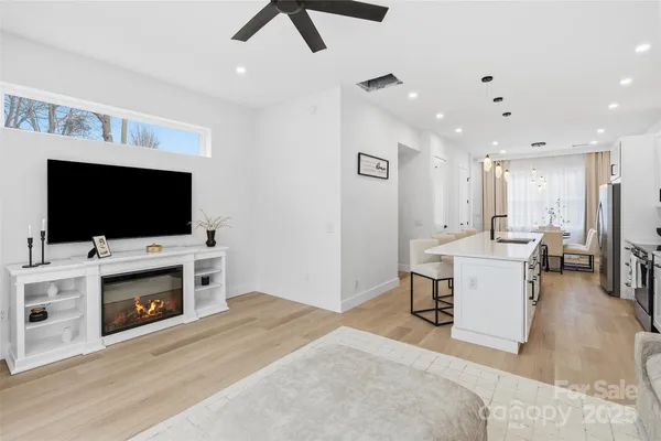 a living room with a flat screen tv a couch and a fireplace