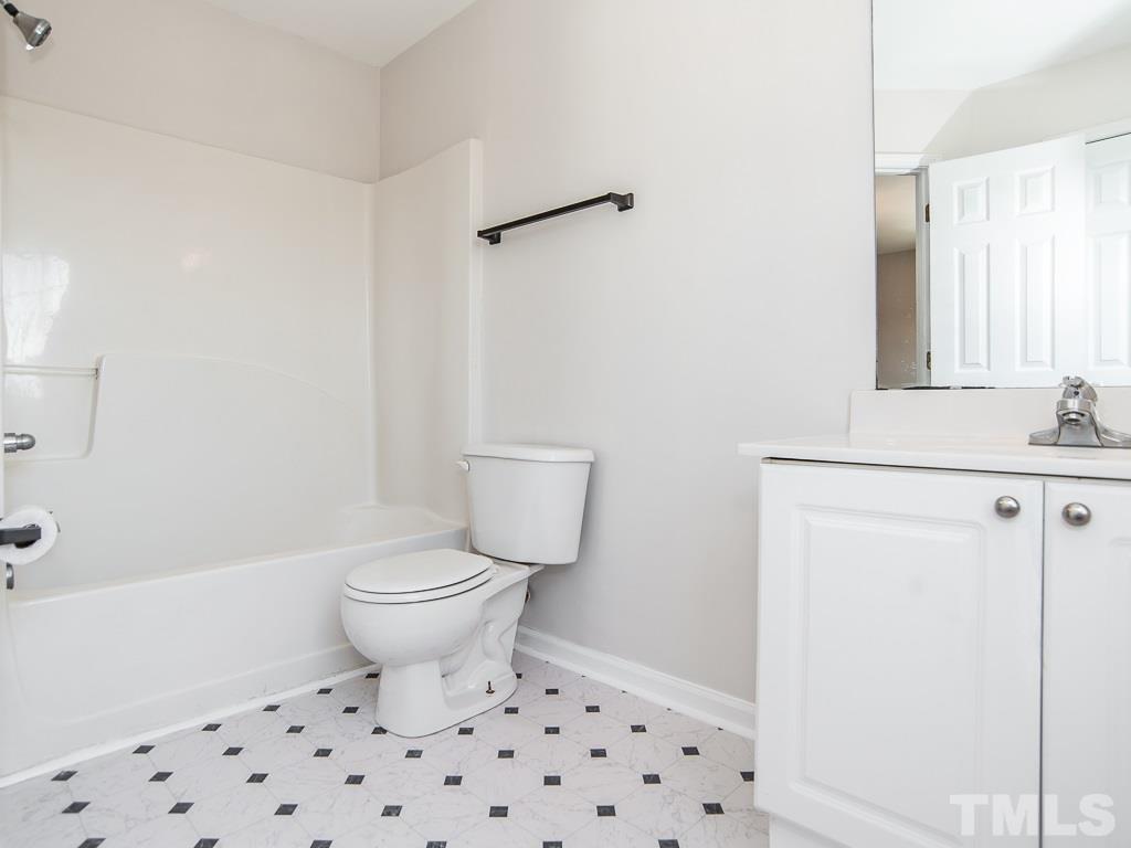 3824 Pin Oak Road Raleigh, NC 27604 - Photo 19 of 27 a white toilet sitting next to a bathroom sink