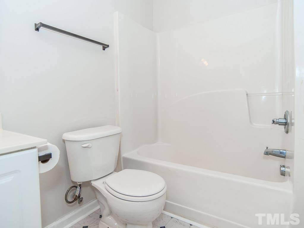3824 Pin Oak Road Raleigh, NC 27604 - Photo 22 of 27 a bathroom with a granite countertop toilet a sink and bathtub